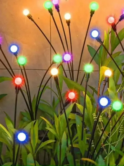 These solar-powered "firefly" lights look like a swarm of magical lights dancing among your plants. The multi-colored bulbs add a playful and festive atmosphere to any garden setting.