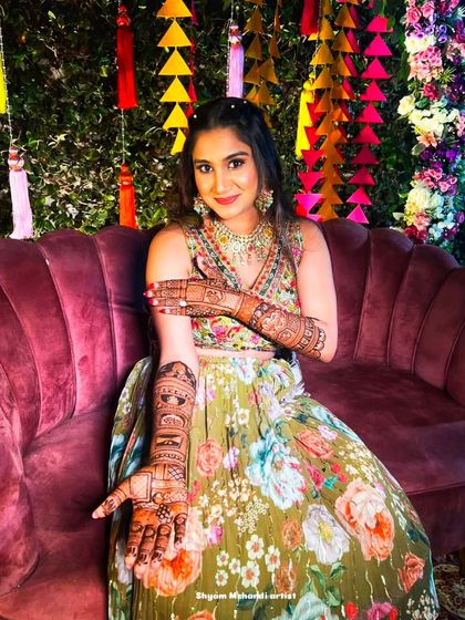 The client from the previous image showing off her full-arm mehandi design.