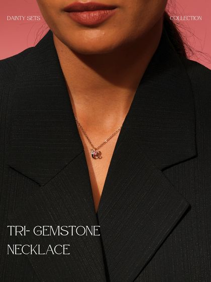 The Tri-Gemstone Necklace, worn to showcase its delicate charm. This piece features a cluster of aquamarine, citrine, and pink tourmaline.