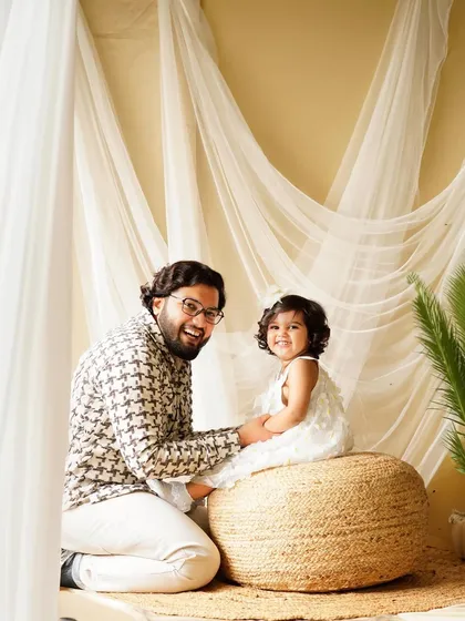 A proud father and his smiling daughter. Capturing the special bond between a dad and his little one is always a cherished part of our family sessions.