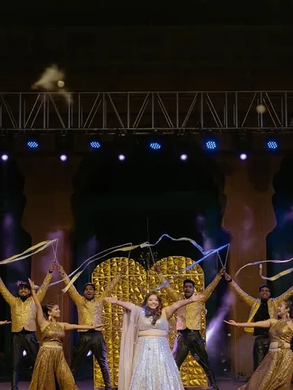 A graceful performance by the bride, enhanced with ribbon props. The golden outfits and warm lighting created an elegant and cohesive look for this sangeet act.