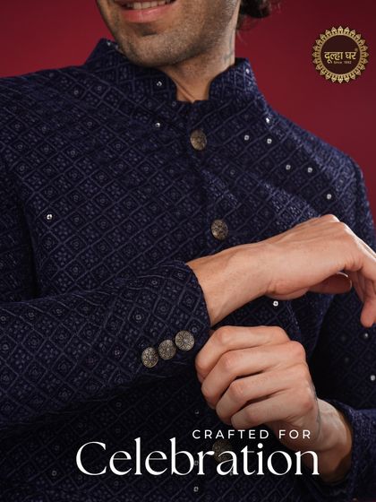 Crafted for celebration. A close-up of a navy blue Bandhgala, highlighting the detailed embroidery and custom buttons.