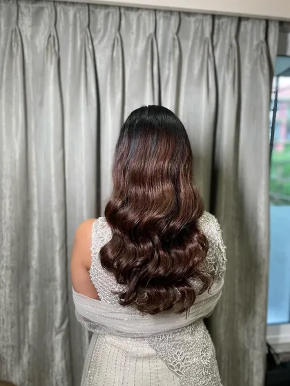 A back view of the glam waves, showing the rich color and healthy shine of the hair. This is a popular choice for engagement and Roka ceremonies.