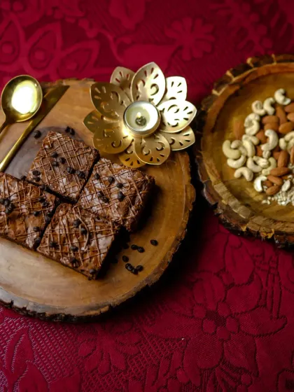 A beautiful flat lay of my Bounty Brownies, surrounded by nuts and a festive diya. These brownies are perfect for gifting during festivals or enjoying as a special treat.