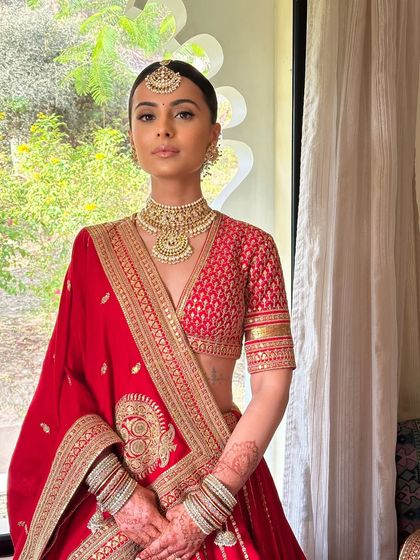 A stunning portrait of the bride, showcasing the clean, sleek bun and minimal makeup that define this modern-classic look.