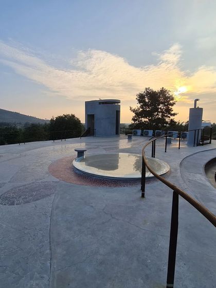 The rooftop terrace, which I call 'Skyliving', is a vast, open deck that becomes a platform for watching the sun set over the hills. The integrated seating and subtle floor patterns create zones for gathering under the open sky.