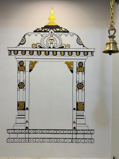 We often create temple gopuram murals for pooja nooks. This design, with its detailed pillars and golden accents, provides a beautiful, built-in frame for the sacred space, even within a compact cabinet.