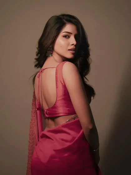 A modern take on a traditional look. This studio portrait focuses on the elegant details of the saree and the model's confident pose, using soft lighting to create a timeless image for her portfolio.