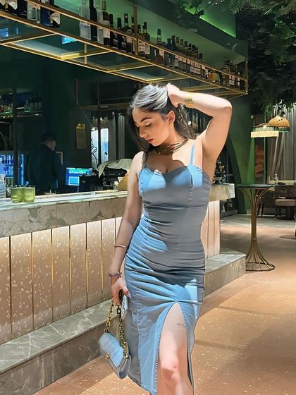 A chic, coordinated look with a blue bodycon dress and a matching bag. This highlights my attention to detail in styling.