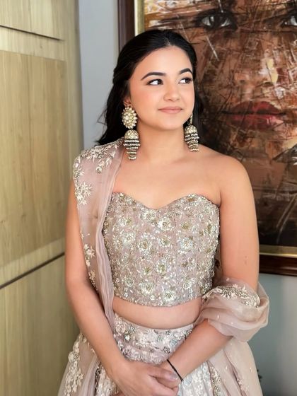 A soft glam look for this beauty. The makeup is minimal but effective, with a focus on glowing skin and softly defined eyes.