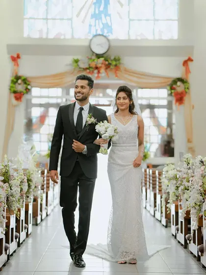 The bride and groom walk down the aisle, united and happy, during their classic church wedding. This demonstrates our experience in capturing the elegance and solemnity of diverse cultural ceremonies.