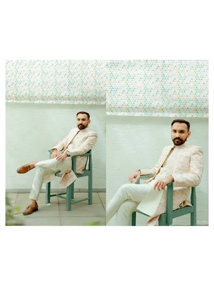 A modern and stylish portrait of the groom, seated and looking sharp in his wedding attire. The clean background and confident pose make for a great shot.