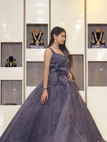 This purple ball gown with a large bow detail is a true fairytale dress, perfect for making a grand statement.