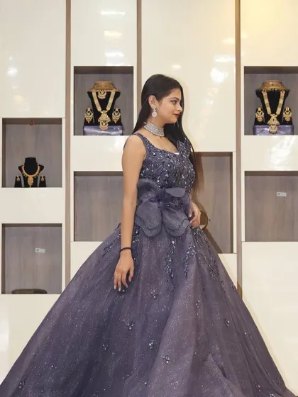 This purple ball gown with a large bow detail is a true fairytale dress, perfect for making a grand statement.