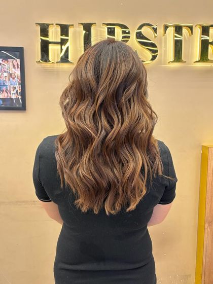 This back view showcases a winter-inspired balayage with warm, rich tones. The color is perfect for adding depth and dimension during the colder months.