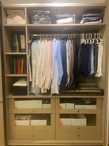This wardrobe combines storage for clothing, files, and other household items, demonstrating how we can create multi-purpose organizational systems.