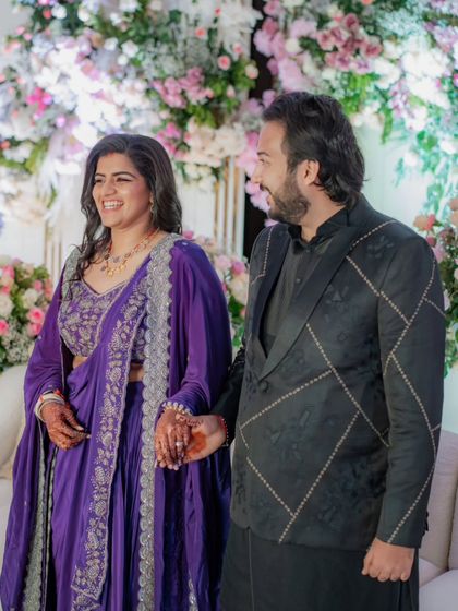 The bride and groom at their formal reception. This was a last-minute event, so we quickly customized this stunning purple outfit for the bride, proving that even with little time, we can create something truly special.