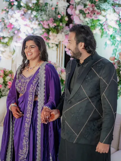 The bride and groom at their formal reception. This was a last-minute event, so we quickly customized this stunning purple outfit for the bride, proving that even with little time, we can create something truly special.