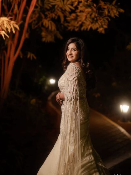 A canvas of ivory, carved in cutwork. This lehenga is for the bride who doesn’t need shimmer to shine, just craftsmanship that speaks softly and stuns boldly.