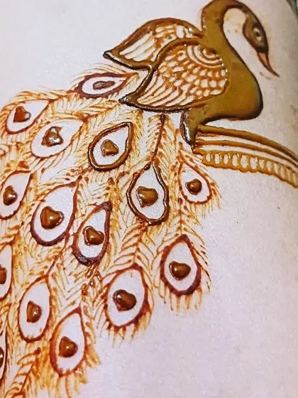 A detailed look at a peacock design, showing the intricate feather work and shading that gives the motif depth and beauty.