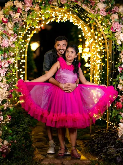 A stunning night shot in our floral archway, lit with hundreds of fairy lights. The bride's vibrant dress looks amazing in this magical setting.