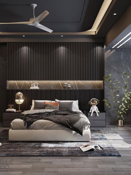 Another take on dark mode. This bedroom uses vertical fluted paneling and a marble headboard shelf to create a sophisticated and moody atmosphere. Whimsical dog figurines add a touch of personality.