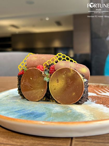 A close-up of our intricate chocolate dessert, showcasing the detailed honeycomb and gold-dusted chocolate discs.