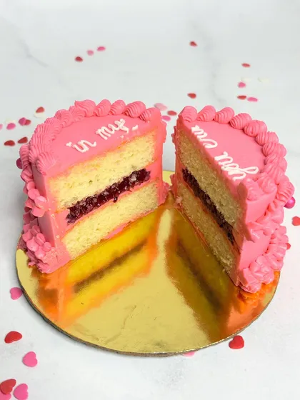 Here's a look inside my mini vintage cake. This is my 3 Berry Victoria flavour, featuring layers of fluffy vanilla sponge and my signature house-made berry compote, all wrapped in pretty pink buttercream. I believe a cake should taste even better than it looks, and this cross-section proves it.