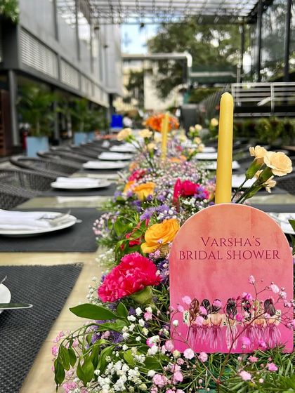 Details matter. For this bridal shower, we created a custom paddle-style menu that sat within the colorful floral table runner, adding a personal and thoughtful touch to the tablescape.