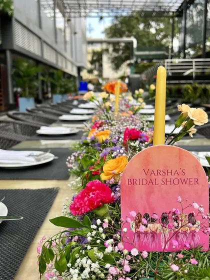 Details matter. For this bridal shower, we created a custom paddle-style menu that sat within the colorful floral table runner, adding a personal and thoughtful touch to the tablescape.