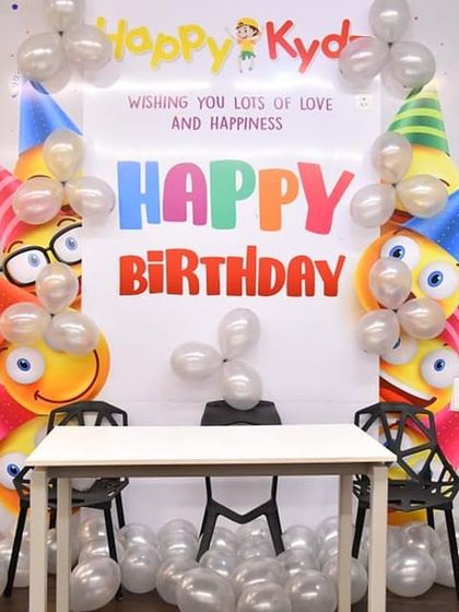 Here is a look at our standard birthday party setup before the guests arrive. We provide a decorated backdrop, table, and chairs, all ready for your cake and presents.