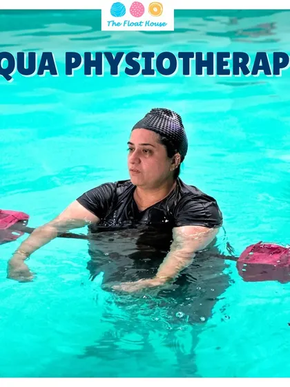 A client focuses during an aqua physiotherapy exercise using aquatic dumbbells. The water provides both support and resistance, making it an ideal environment for building strength during rehabilitation.