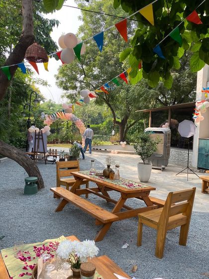A wide view of the outdoor restaurant area decorated for a birthday party.