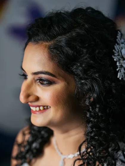 I absolutely love working with natural curls. For this bride, we created a soft glam look that enhanced her features while letting her beautiful curly hair be the star of the show.