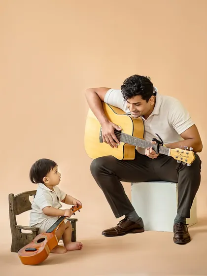 A beautiful moment of connection between uncle and nephew, sharing their love for music. These are the candid moments that become treasured memories.
