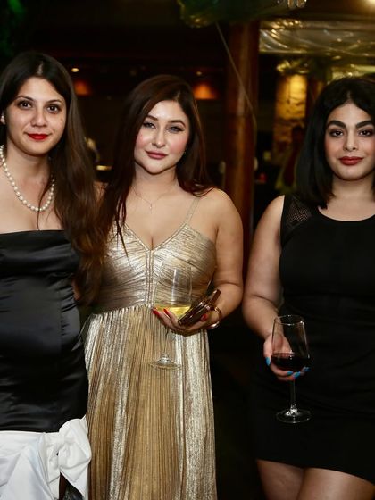 The glamorous attendees of the Polo Season celebration, enjoying a night of drinks and conversation.