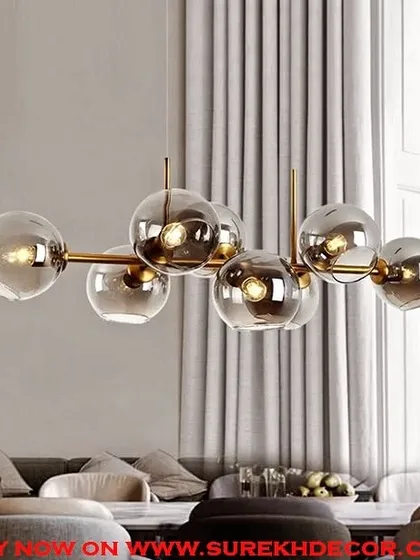 This modern chandelier features eight smoked glass globes on an antique brass frame. The "concreteness check" design offers a bold, molecular-inspired structure that is perfect for a contemporary living or dining room.