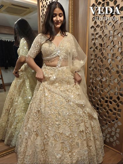 A breathtaking cream and gold lehenga that’s perfect for a bride's reception or engagement. The heavy embroidery sparkles beautifully, a truly luxurious pre-loved find.