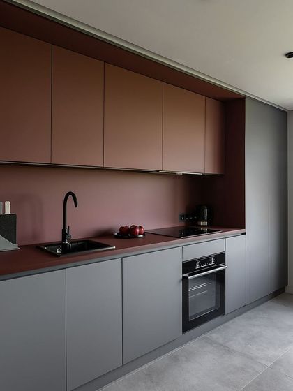 Step into this contemporary kitchen that blends sleek lines with cutting-edge design. The handleless cabinets and integrated oven create a minimalist aesthetic, while the color combination adds a touch of modern elegance.