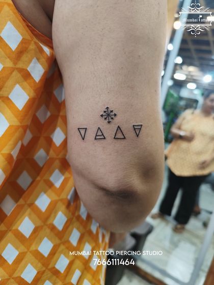 This tattoo features a row of alchemical symbols representing the elements. It's a great example of how we create clean, precise geometric and symbolic tattoos for our clients.
