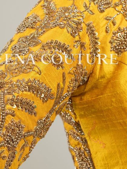 This sunshine yellow raw silk blouse is brought to life with meticulous hand embroidery by my talented artisans. The dense, traditional motifs in antique gold threadwork cover the back and sleeves, creating a piece that radiates warmth and luxury.