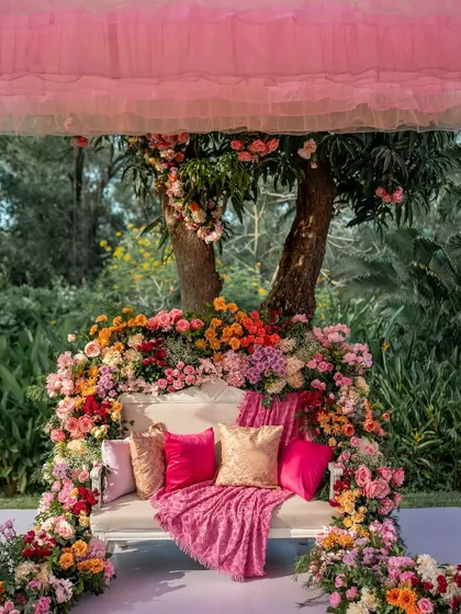 A beautiful floral throne for a Mehendi ceremony. The sofa is completely enveloped in a rainbow of fresh flowers, creating a breathtaking focal point and the perfect photo spot.