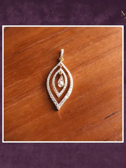 Grace meets sparkle in this exquisite leaf-shaped diamond pendant. The dangling diamond in the center adds a touch of movement and brilliance to your everyday style.