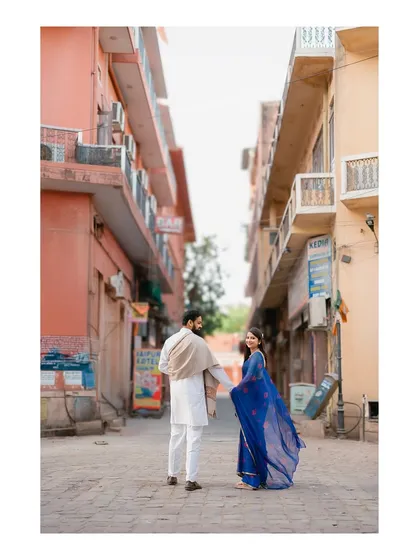 A "follow me" style shot leading through a narrow, colorful lane in Jaipur, creating a sense of adventure and shared journey.
