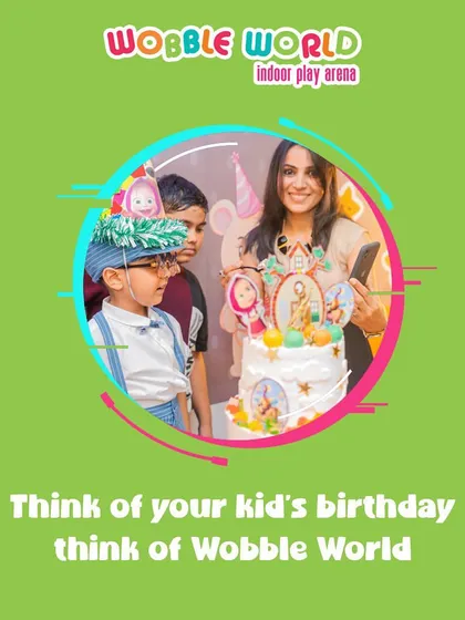 A reminder that when you think of your kid's birthday, you should think of Wobble World. This image shows a happy cake-cutting moment.