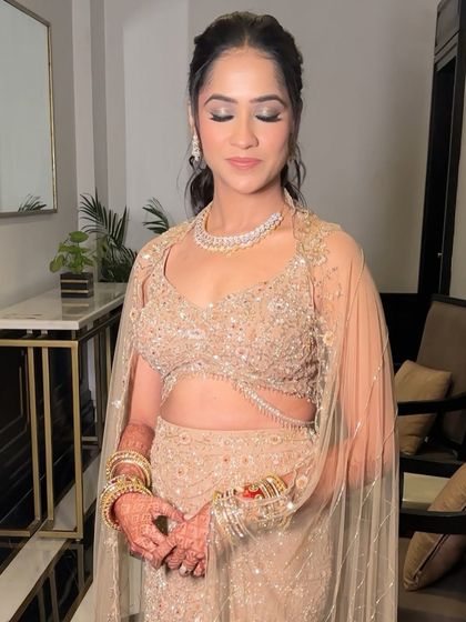 A close-up on the eye makeup for this reception look. A soft, shimmery silver on the lids adds a touch of glam without being overpowering, keeping the overall feel light and romantic.