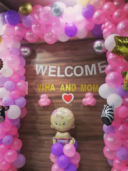 A sweet and simple welcome decoration for a baby and mom, using a pink and purple balloon arch with cute animal foil balloons.