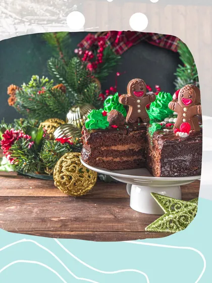 A dreamy, creamy chocolate cake with a festive Christmas vibe. This cake is topped with cute gingerbread man cookies and green frosting, set against a backdrop of holiday decorations.
