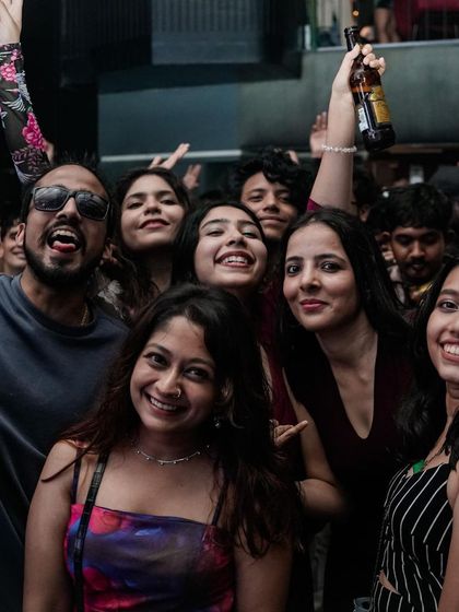 A group of friends posing for a picture, capturing a memory from a great night.