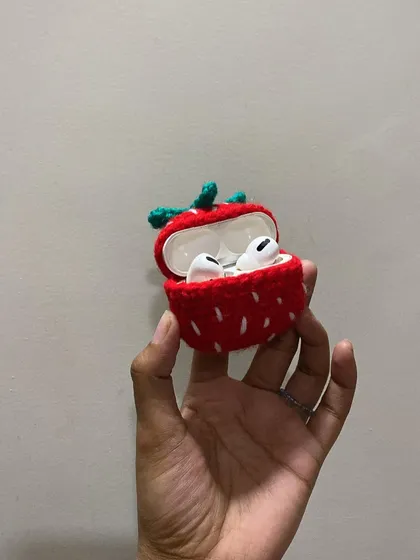 Another look at the strawberry AirPod case, showing how the device fits snugly inside. It's both protective and adorable.